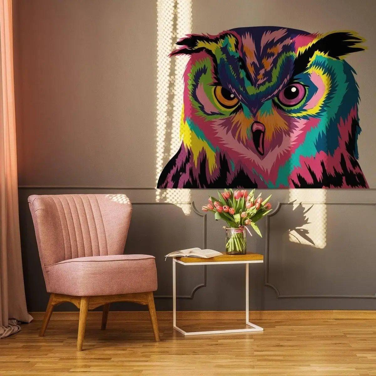 Colorful owl wall sticker in a stylish room, featuring a vibrant design on the wall next to a cozy chair and flowers.