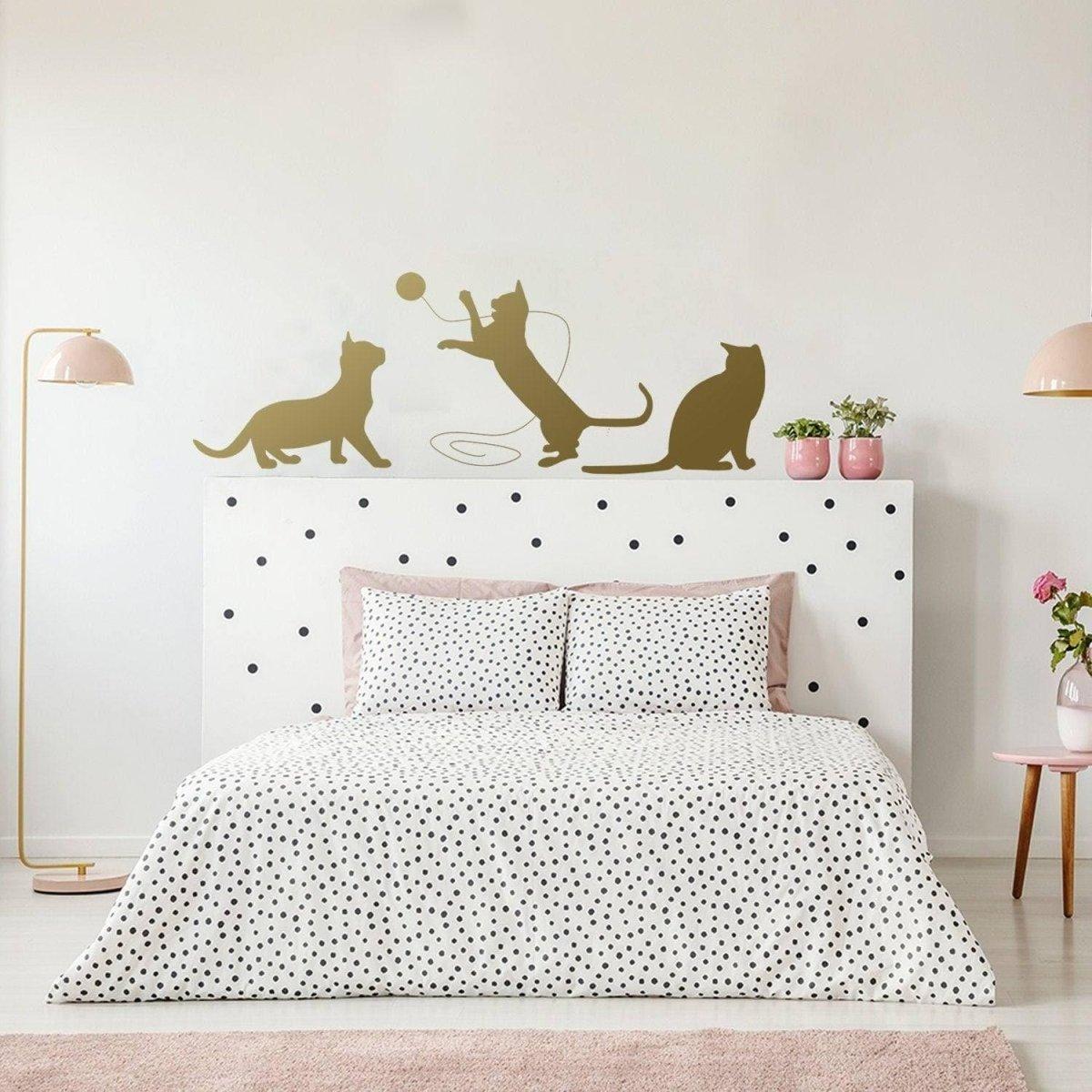 Adorable cat silhouette decal above a bed, perfect for adding charm to pet-themed room decor.