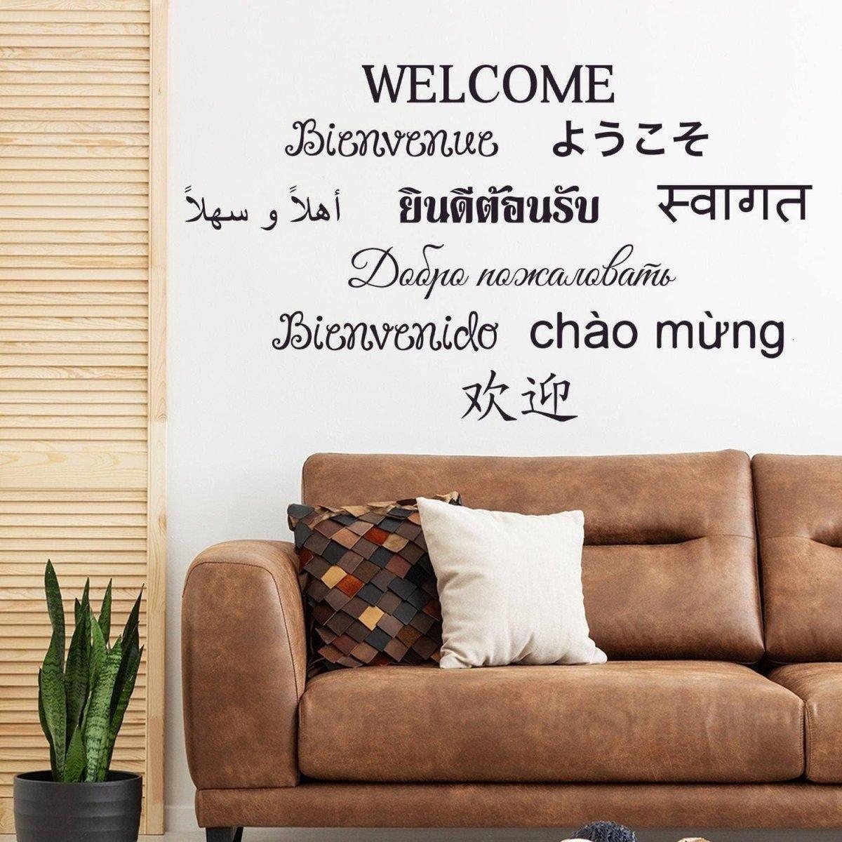 Vinyl wall decals featuring the word 'WELCOME' in multiple languages, adding charm to a modern living room.