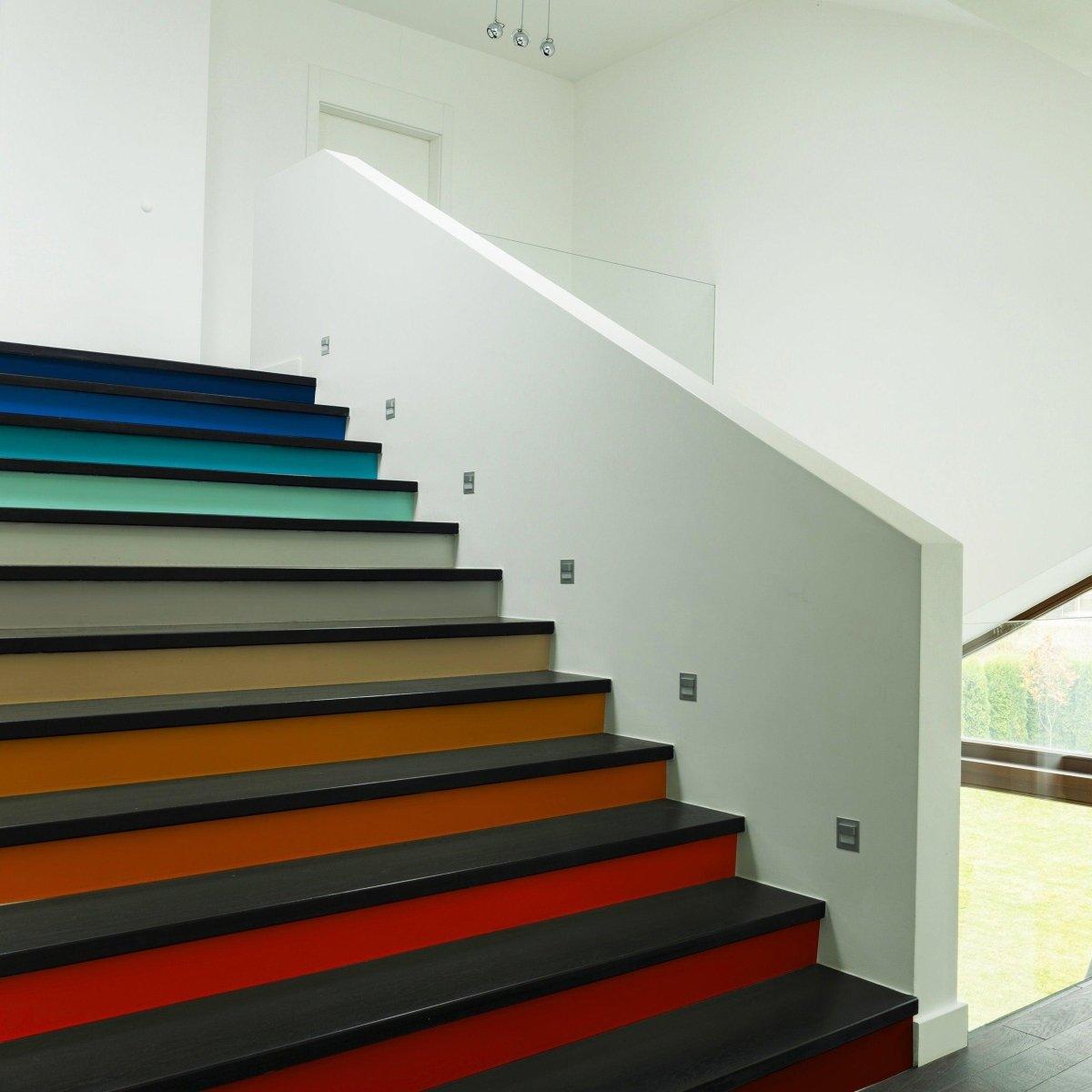 Transform your stairs with vibrant gradient color riser stickers showcasing a stunning staircase revamp.