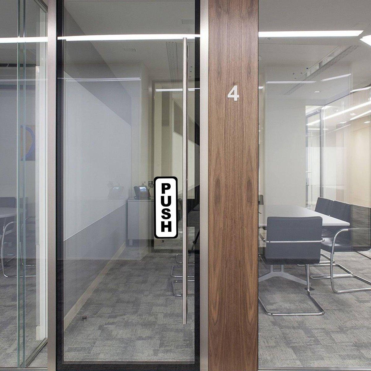 Commercial door featuring a 'PUSH' sticker for easy entry in an office space.