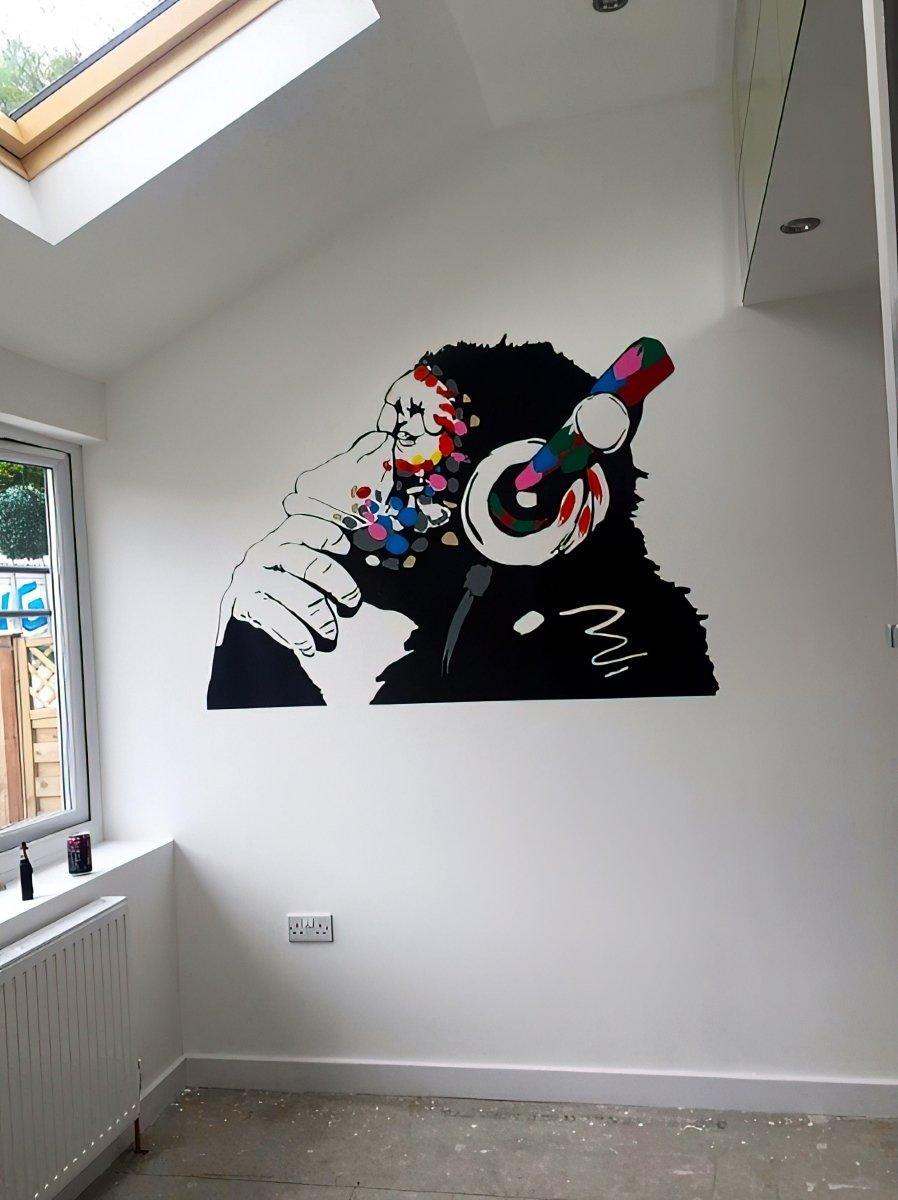 Cool monkey wall decal with colorful headphones, perfect for kids' room decoration and adding personality to any space.