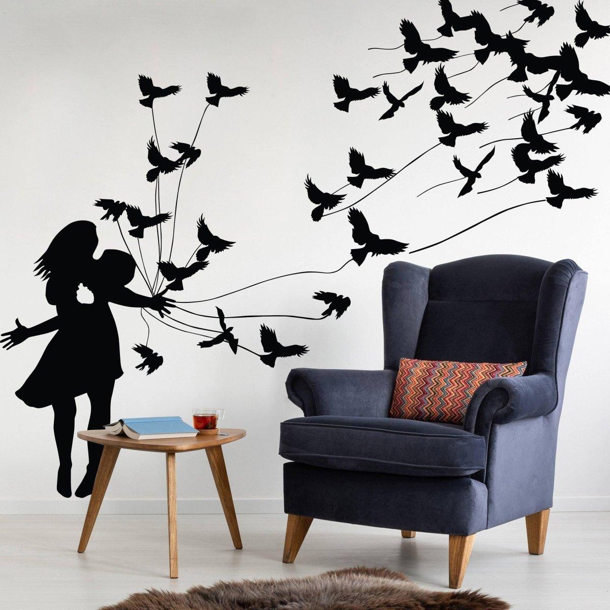 Wall sticker of a girl releasing birds, enhancing interior decor with creative artistic design.