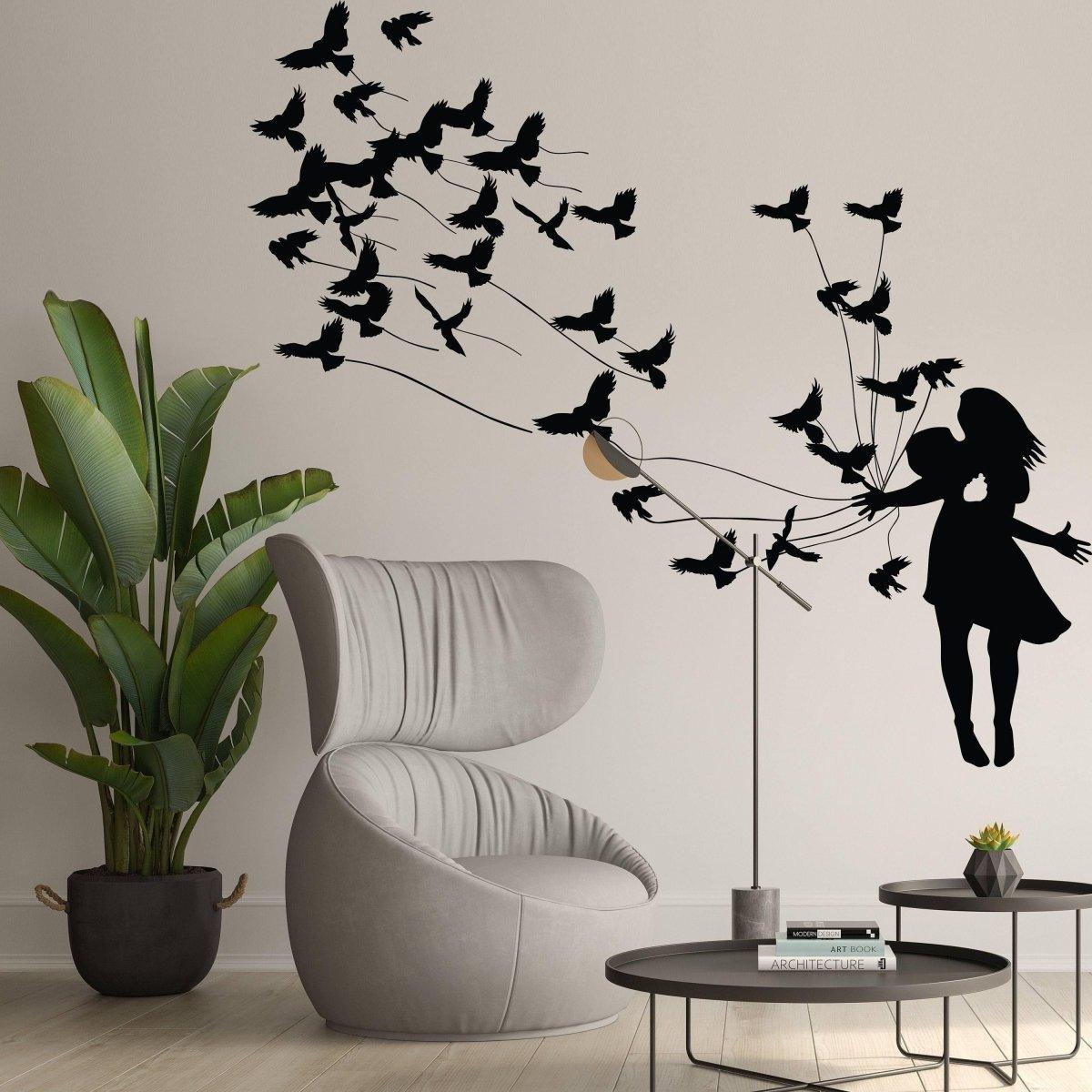 Wall sticker of a girl with birds, decorating a modern living room with a stylish chair and plant.