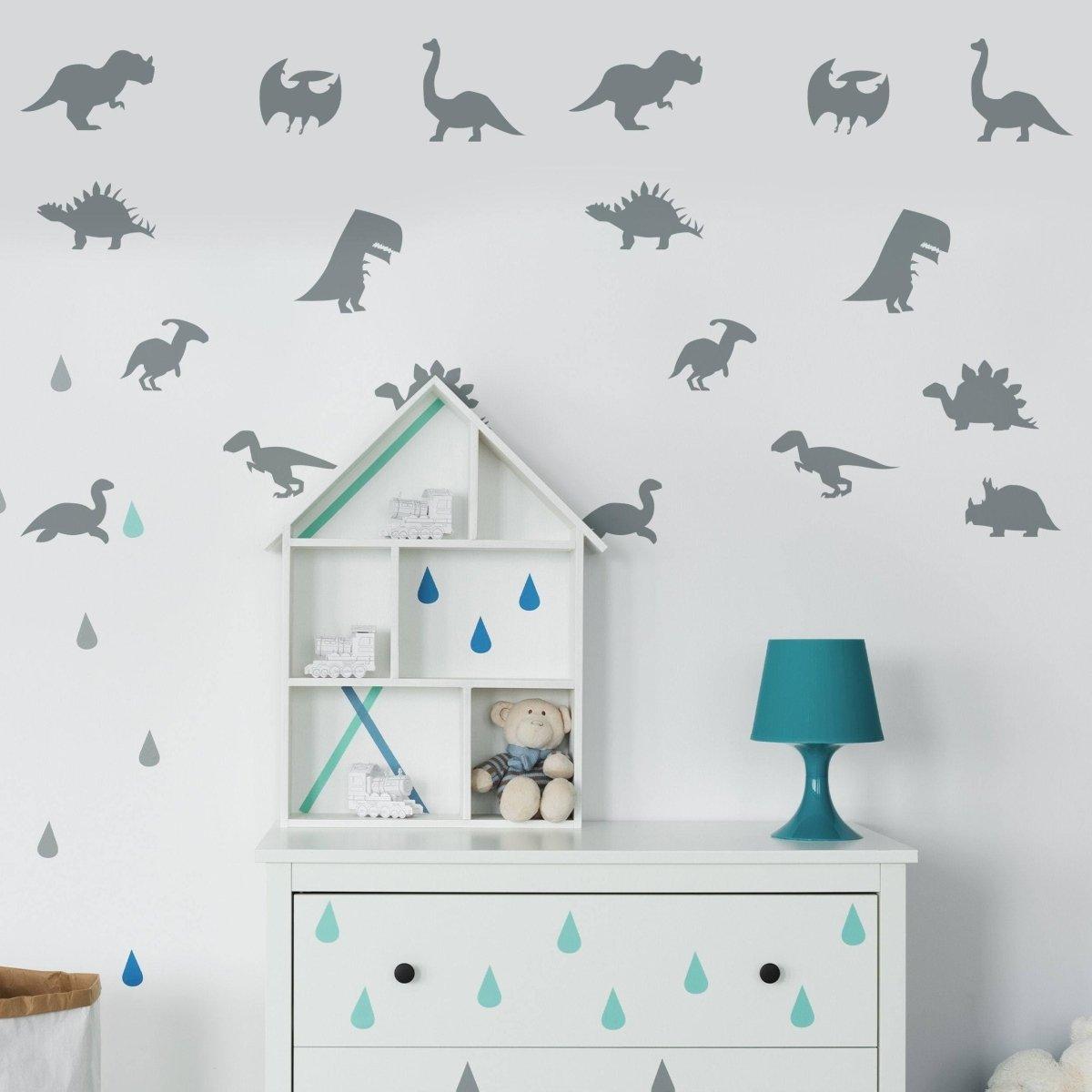 Dinosaur Dreams wall sticker set featuring various dinosaur silhouettes on a nursery wall with decor accents.