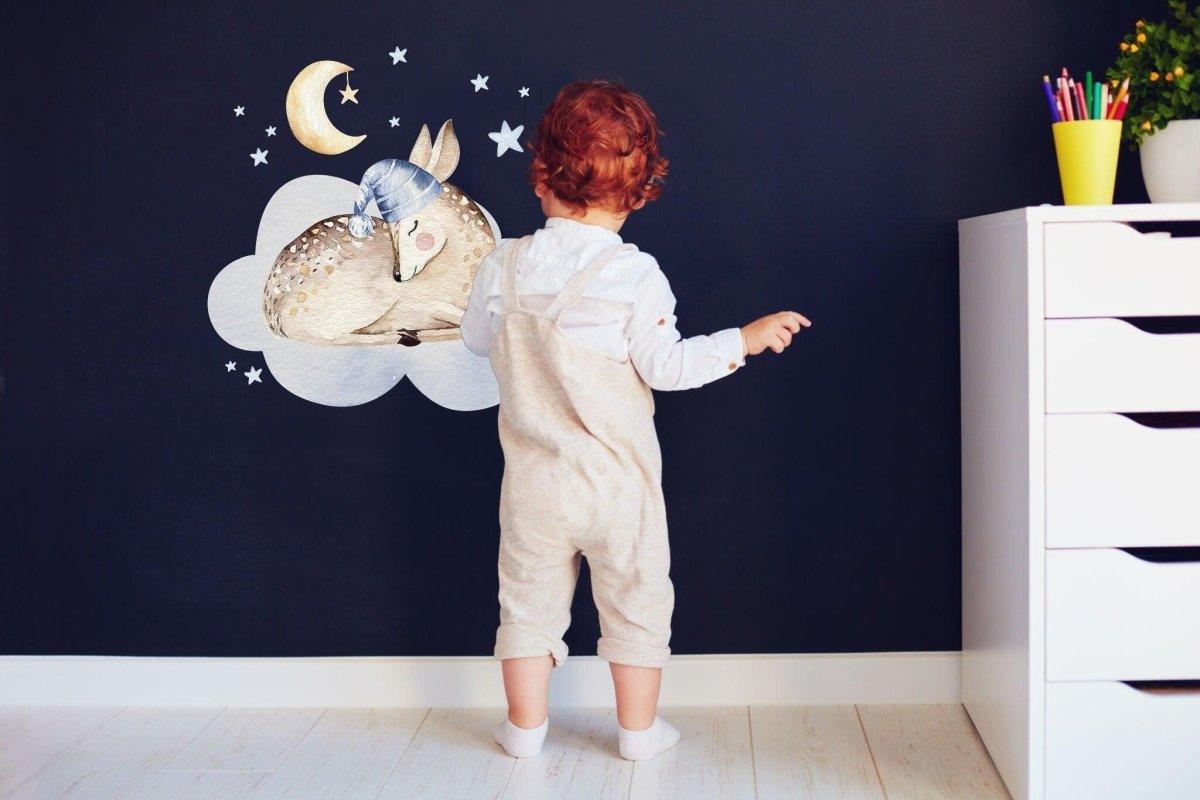 Baby standing near adorable cloud and animal decals on nursery wall, perfect for children's room decor.