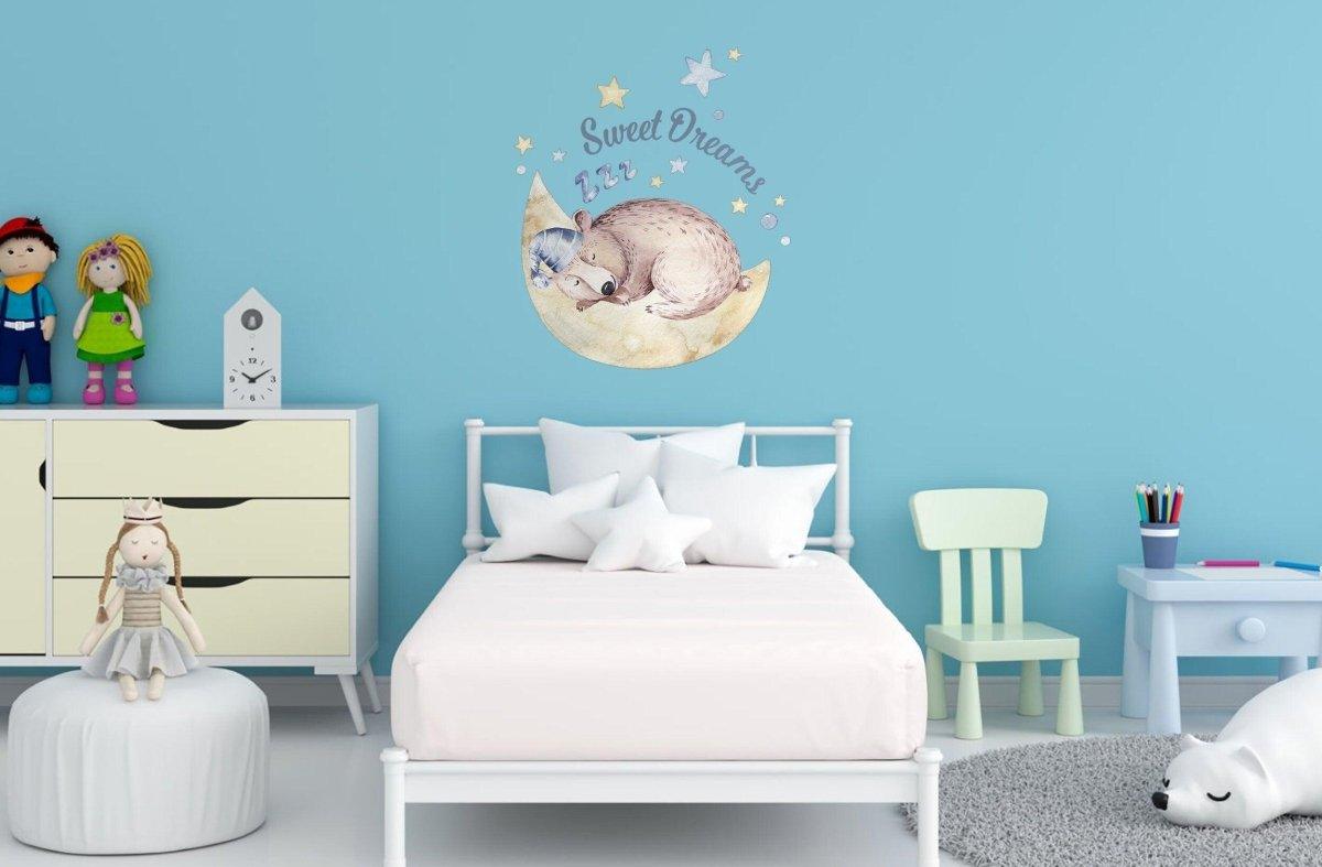 Cute nursery with Sweet Dreams wall decal featuring a sleeping animal on blue wall, perfect for baby room decor.