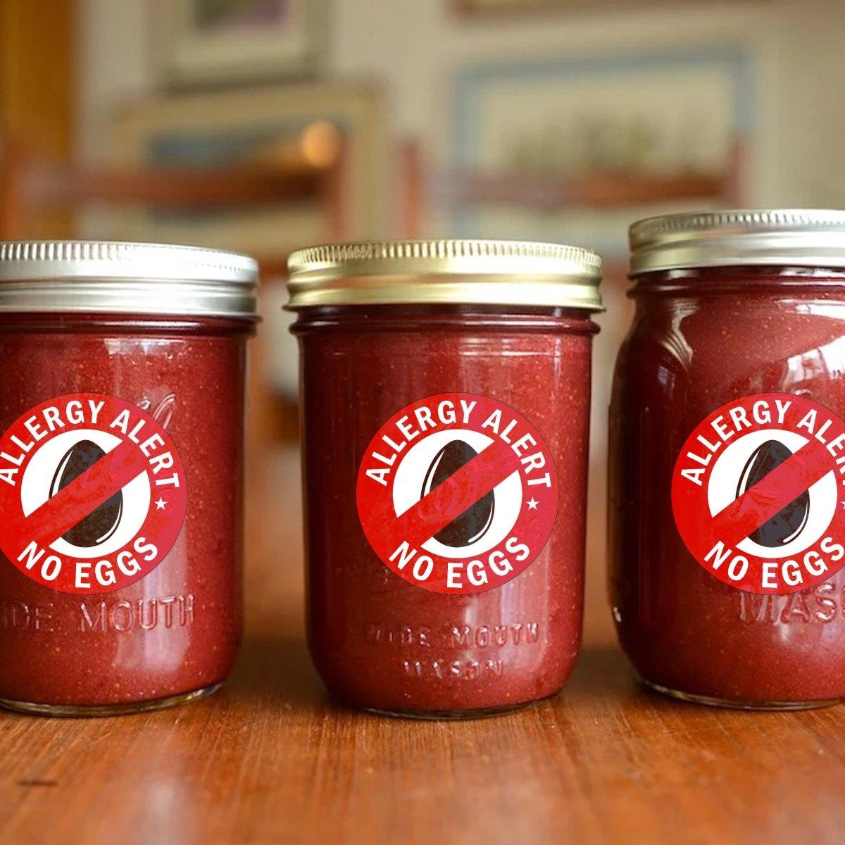 Three jars with 'Allergy Alert No Eggs' stickers, promoting safety for egg allergies in food storage.