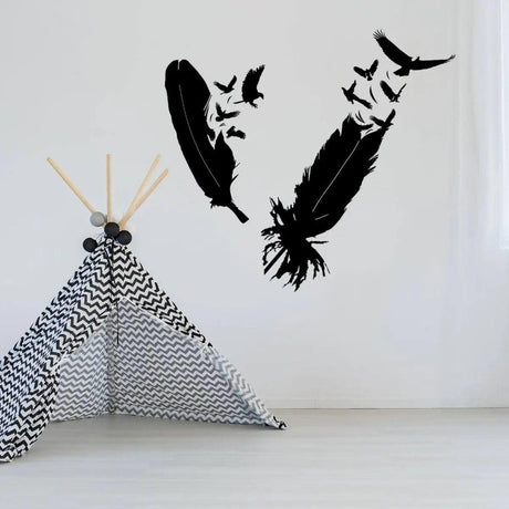 Stylish bird feather wall sticker design in black on a white wall above a geometric play tent.