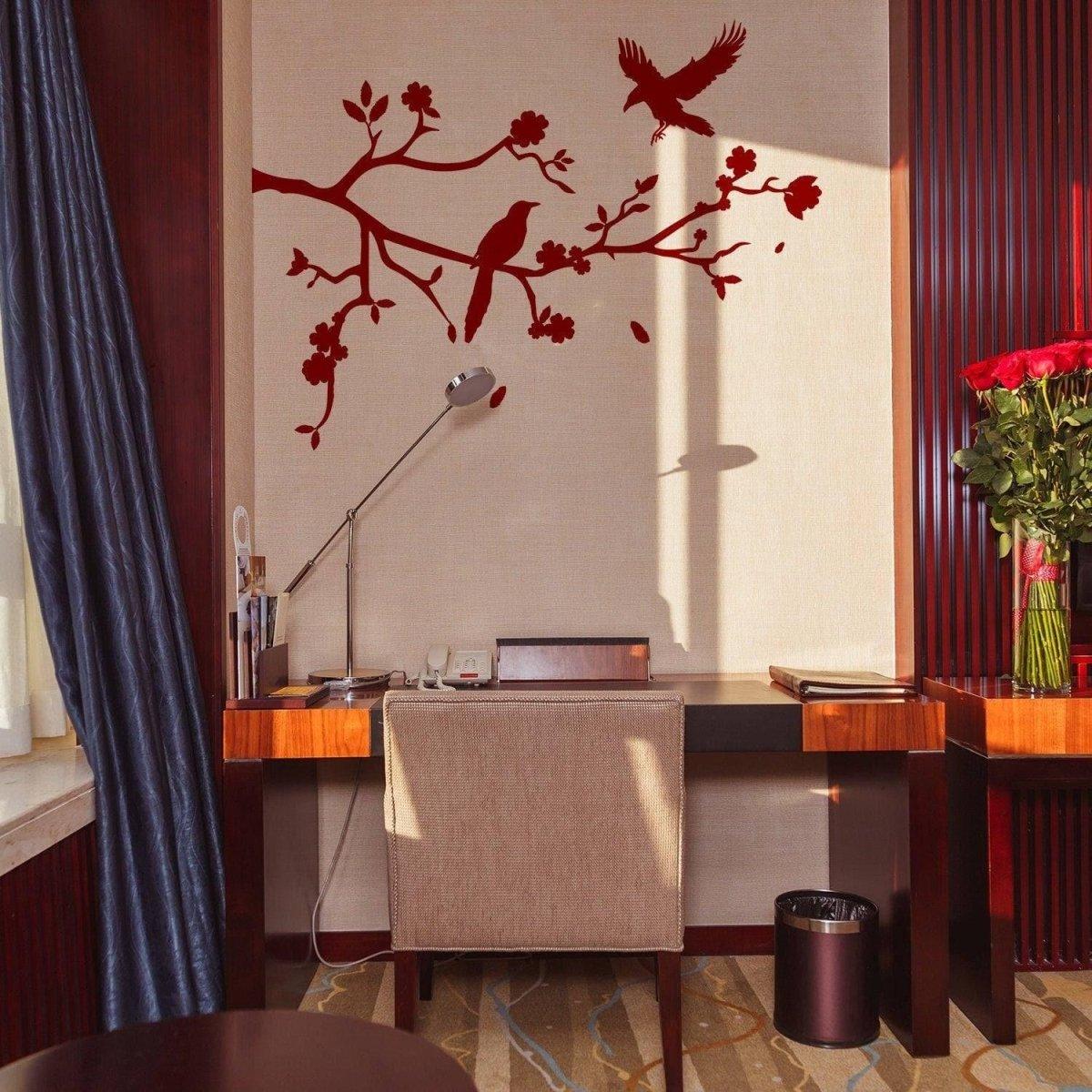 Chic tree branch wall decal featuring birds, enhancing a stylish home office décor with vibrant red accents.