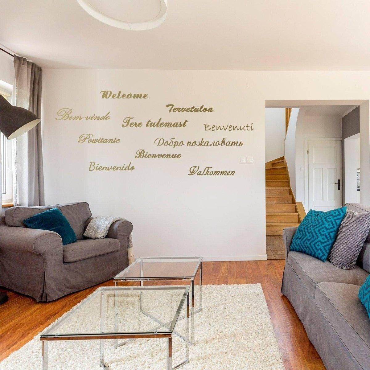 Stylish living room with a welcoming wall decal featuring multilingual greetings on a modern interior design.