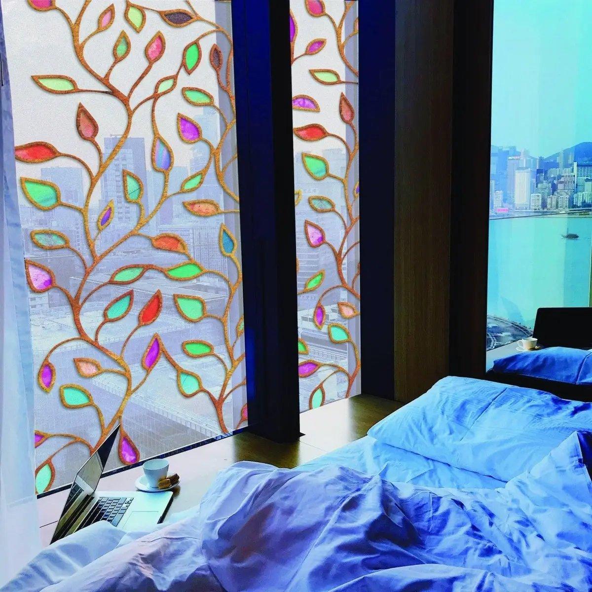Elegant leaf design window film providing privacy and style in a modern bedroom with a city view.