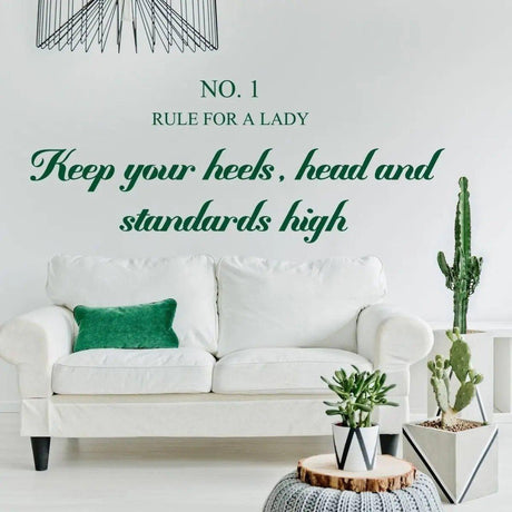 Chic wall sticker with motivational quote 'Keep your heels, head and standards high' in green, enhancing stylish interior decor.