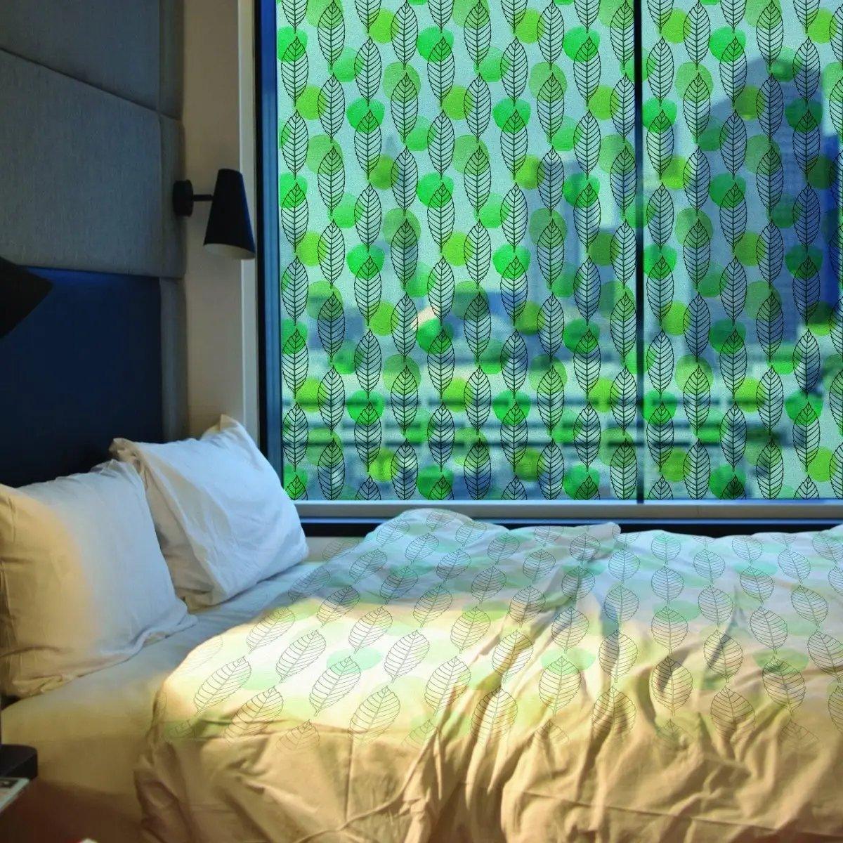 Leaf pattern etched glass film providing privacy and natural light in a cozy bedroom setting.