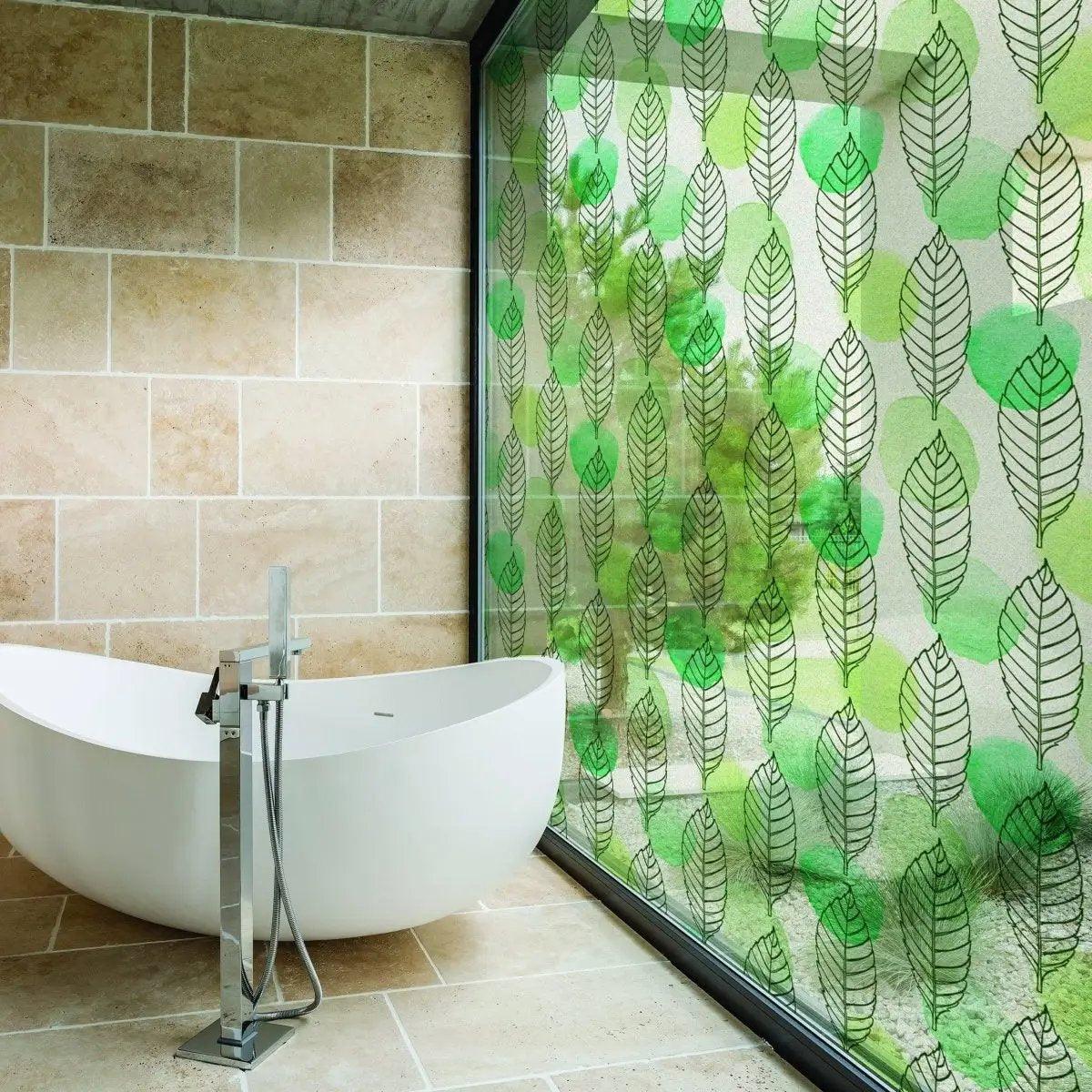 Stylish etched glass film with leaf design for privacy in a modern bathroom setting.
