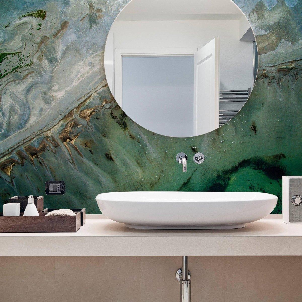 Chic marble design self-adhesive wallpaper in modern bathroom with round mirror and sleek sink.