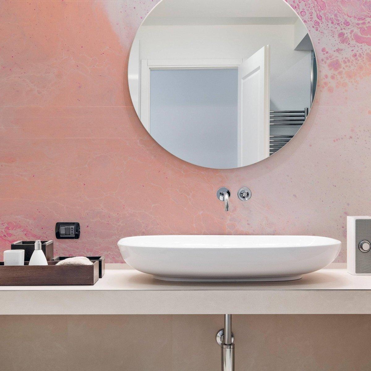 Elegant marble self-adhesive wallpaper in a modern bathroom with round mirror and stylish washbasin.