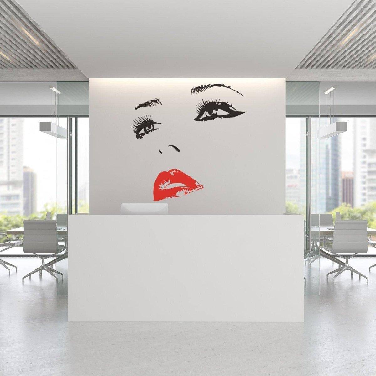 Elegant woman face wall decal in modern office with red lips, enhancing the interior decor with charm.
