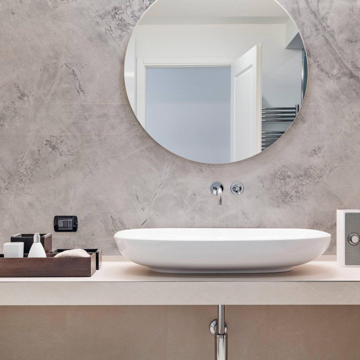 Elegant bathroom featuring stone texture self-stick wallpaper, round mirror, and modern sink for stylish décor.