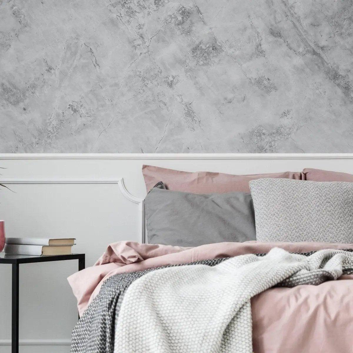 Elegant bedroom featuring stone texture self-stick wallpaper with gray and pink bedding decor.