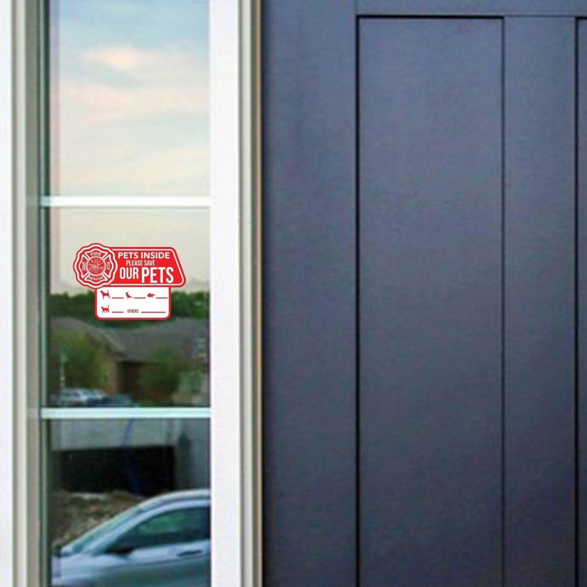 Emergency pet alert cling sticker on a door window indicating pets are inside the house for safety.