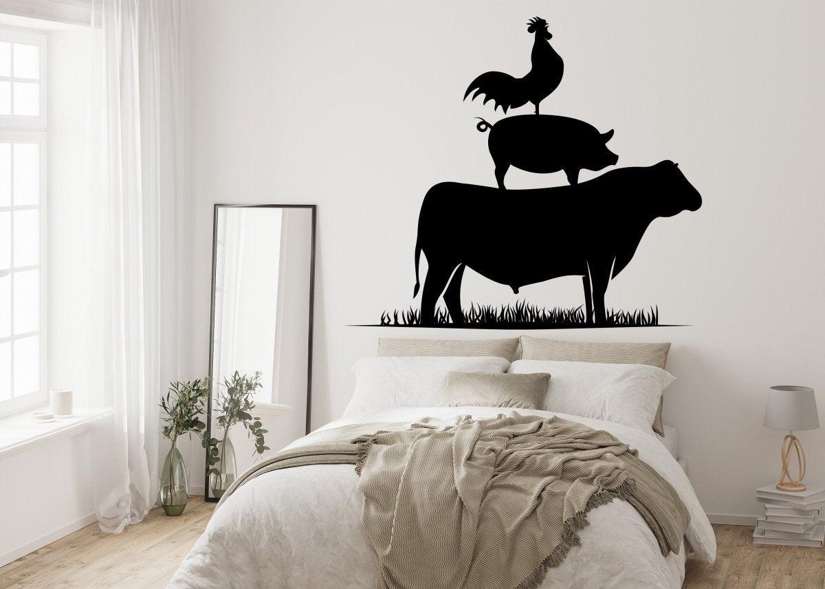 Charming wall art decal featuring a rooster on a pig atop a cow, adding a whimsical farm touch to a cozy bedroom.