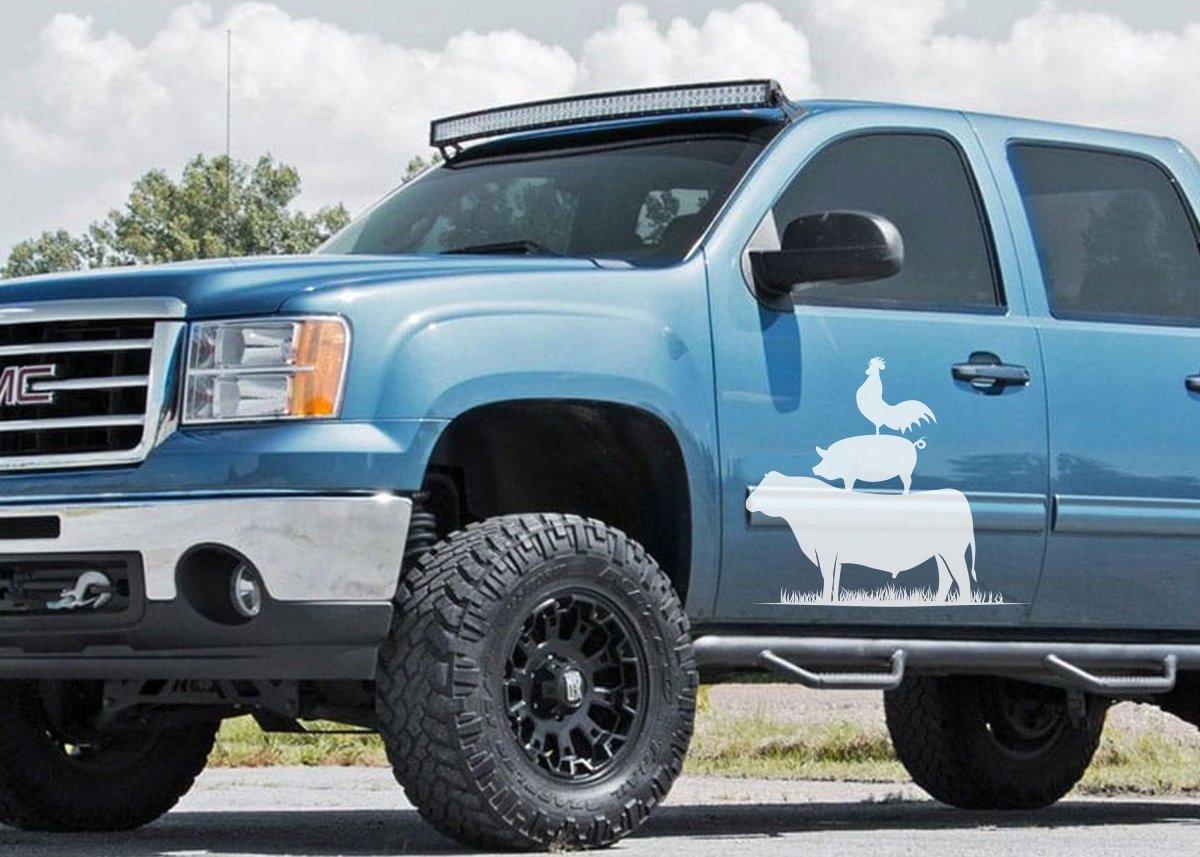 Blue truck with a fun farm animal decal featuring a cow and a chicken on the side, perfect for animal lovers.