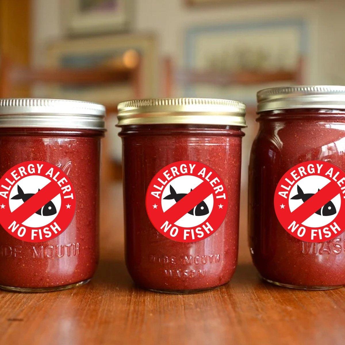 Three jars with bright red 'Allergy Alert No Fish' stickers for fish allergy safety awareness.