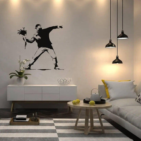 Artistic wall decal featuring a figure throwing flowers in a modern living space with stylish decor.