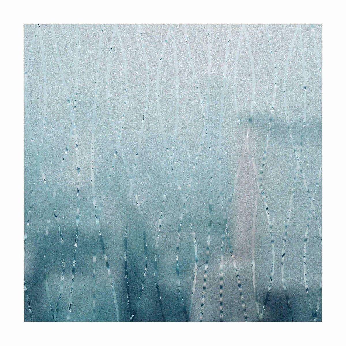 Frosted glass door sticker with elegant wave design, enhancing privacy while allowing natural light to enter.