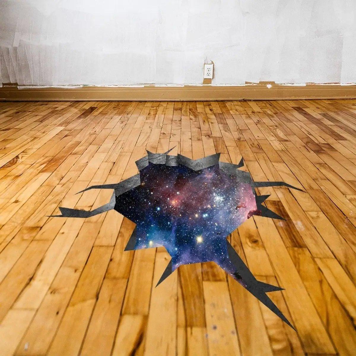 3D galactic illusion wall decal sticker on wooden floor, creating a mesmerizing space-themed effect.