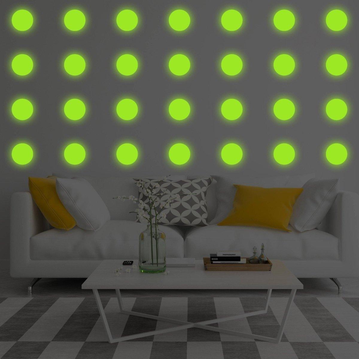 Glow in the dark wall stickers illuminated on a living room wall, enhancing modern galaxy decor.