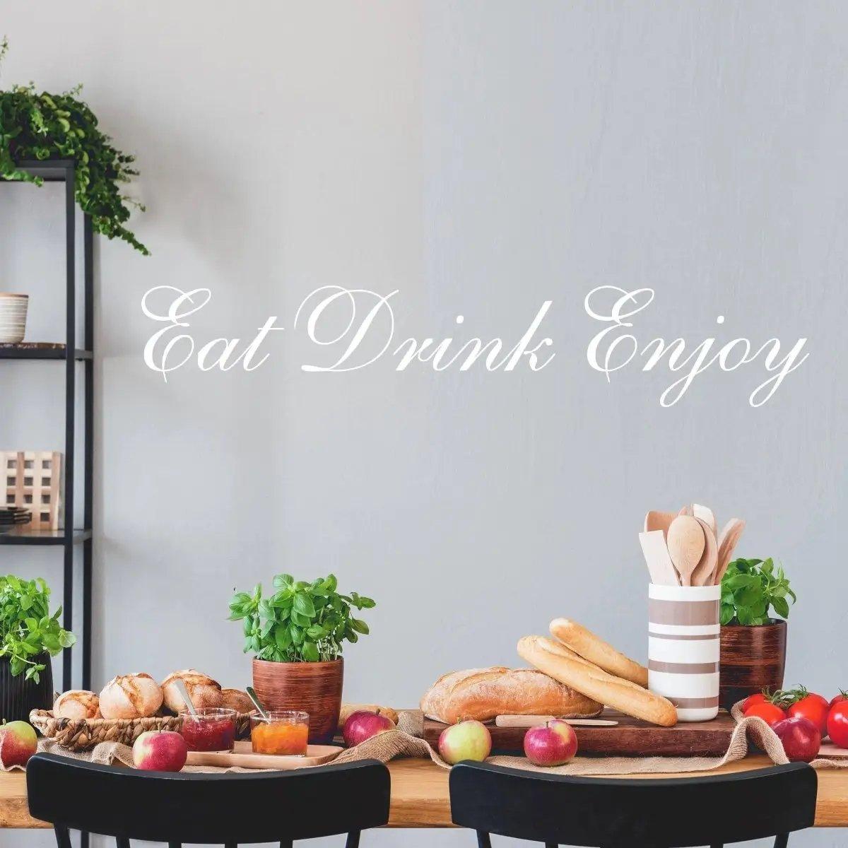 Illuminated kitchen with 'Eat Drink Enjoy' vinyl decal on wall, featuring fresh food and decor.