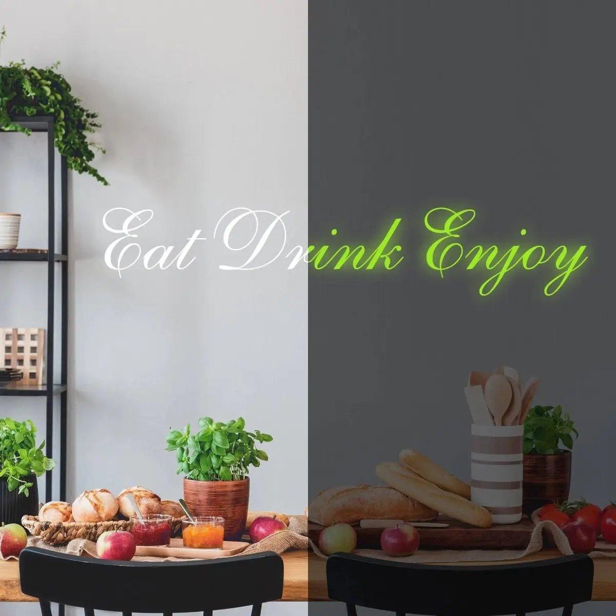 Illuminated Eat Drink Enjoy vinyl decal in a cozy kitchen setting with fresh herbs and fruits.