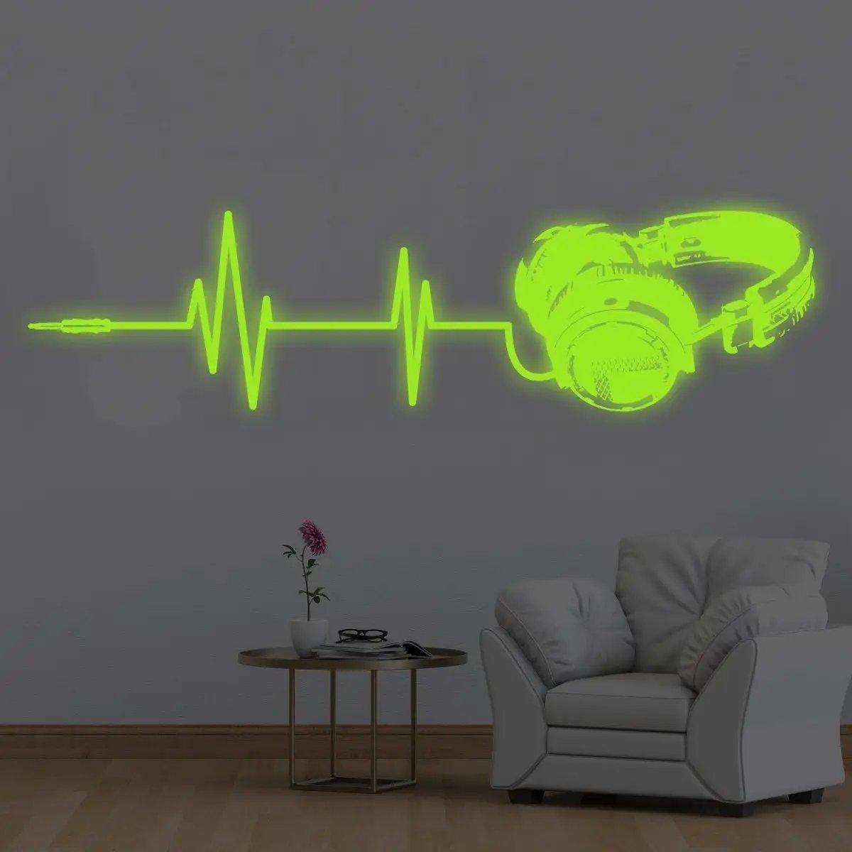 Luminous vinyl wall decal of headphones and sound wave design, glowing in the dark for a unique room decor.