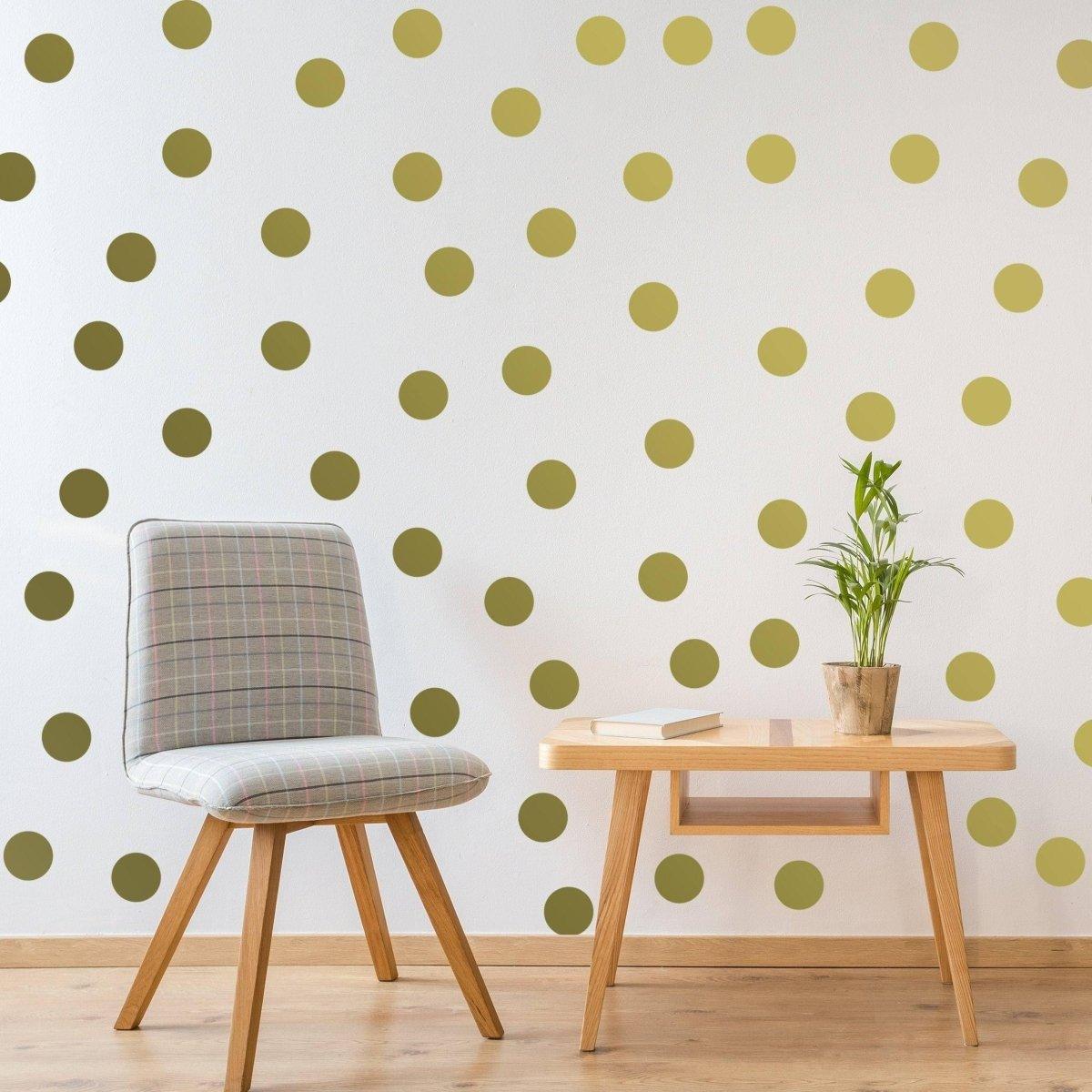 Elegant gold circle wall decals on a white wall with a stylish chair and plant, perfect for home decor.