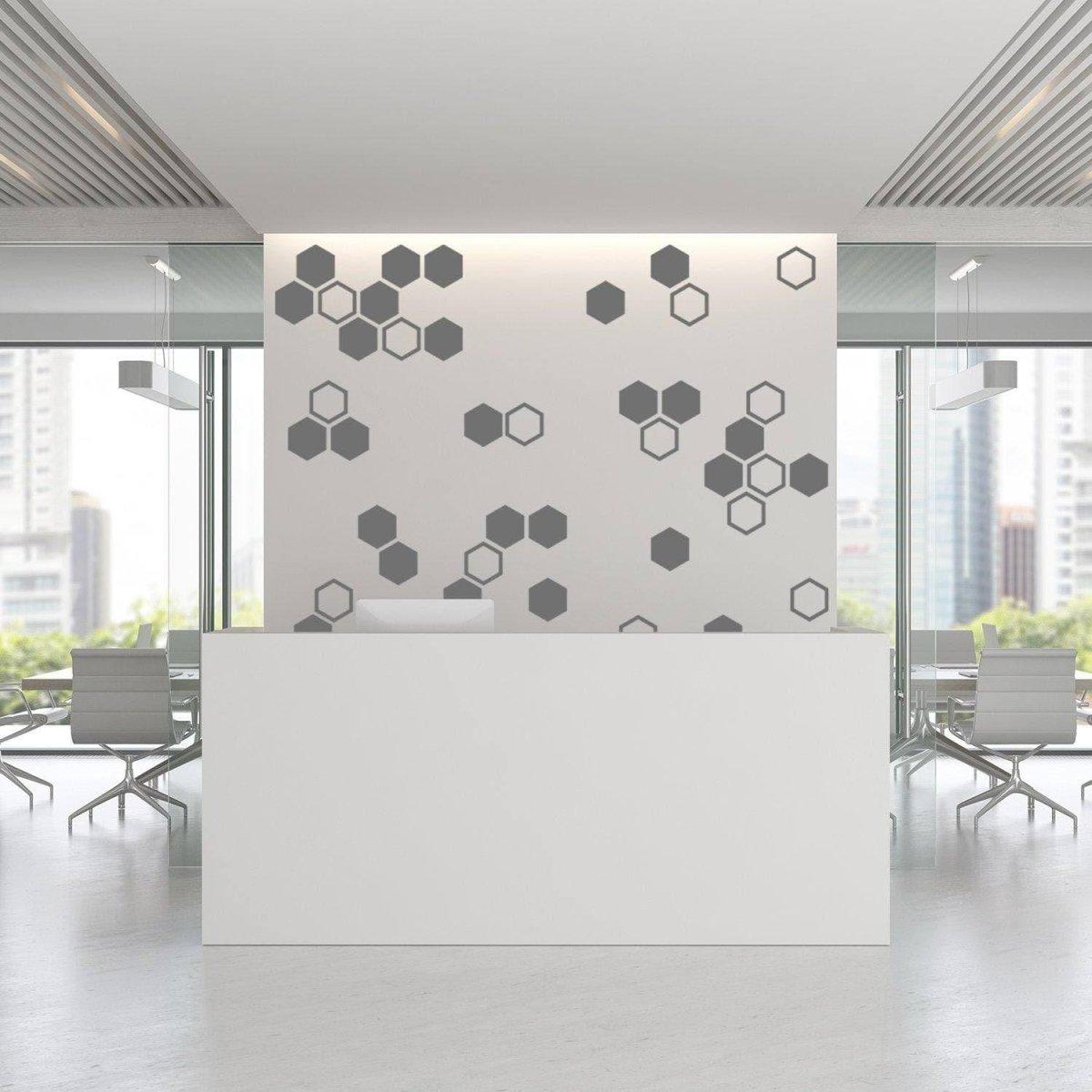 Modern office reception with geometric hexagon wall decals in gray tones, enhancing the stylish decor.