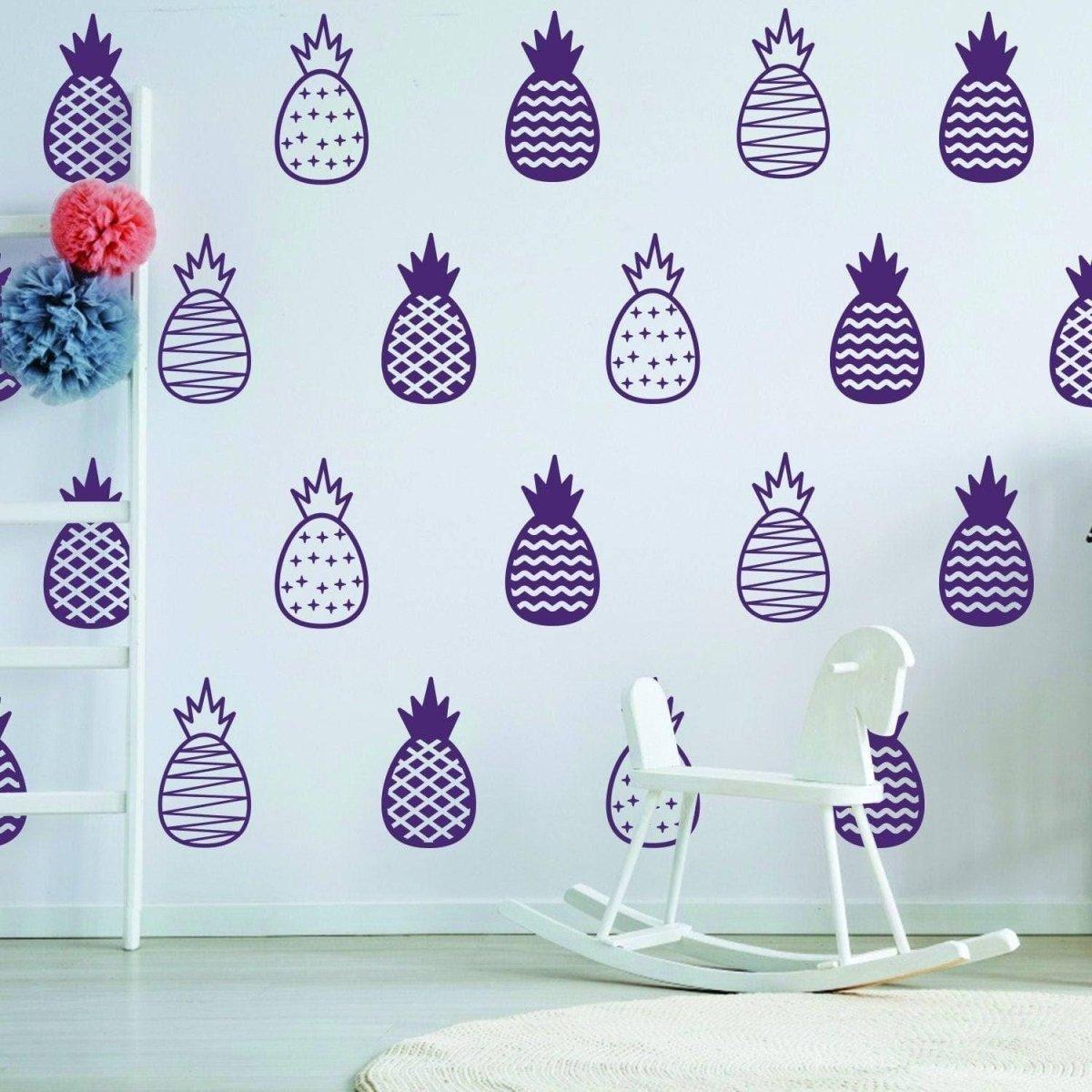 Chic vinyl wall decals featuring purple pineapples on a white wall, adding whimsy to a stylish room.