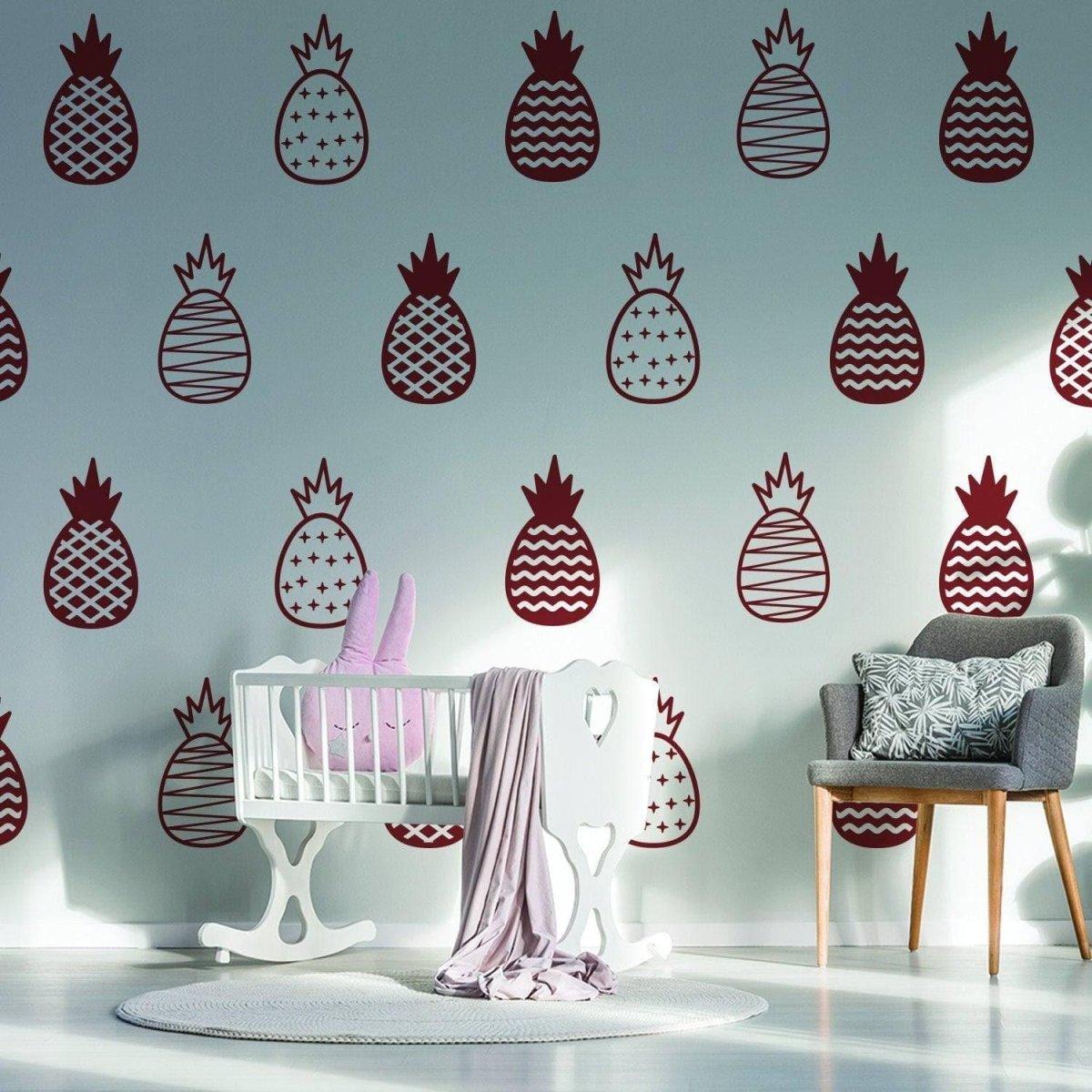 Chic vinyl wall decals featuring whimsical pineapples in a stylish nursery with crib and modern decor.