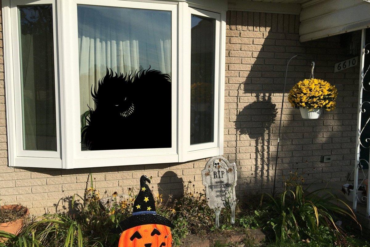 Spooky monster silhouette window decal for Halloween decor, perfect for creating eerie vibes.