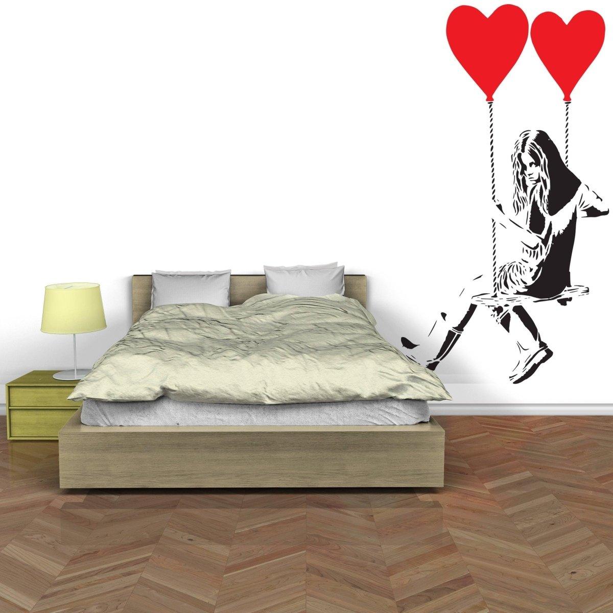 Vinyl heart balloon wall decal above a cozy bed, adding a creative touch to the bedroom decor.