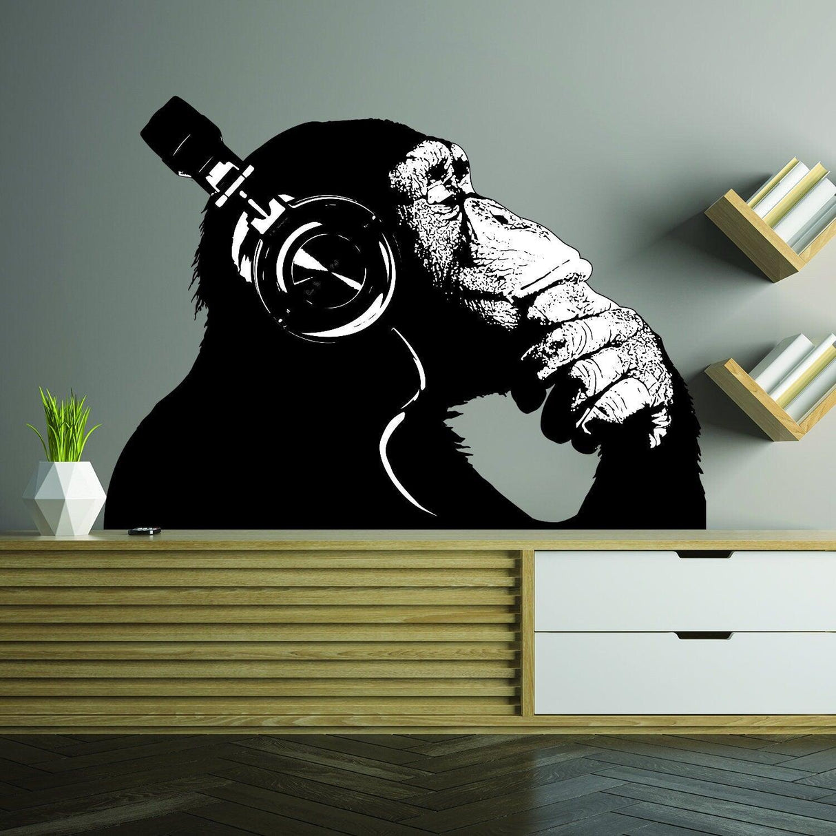 Banksy wall decal of a thinking monkey wearing headphones, perfect for home decor.