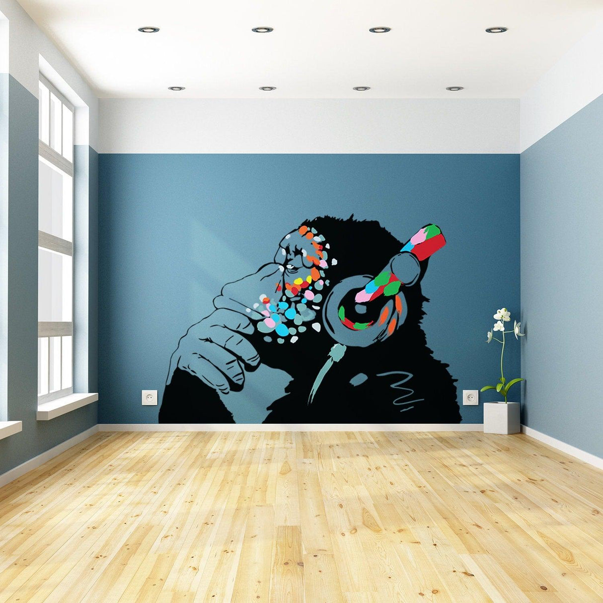 Colorful mural of a monkey wearing headphones in a modern room with wooden flooring.