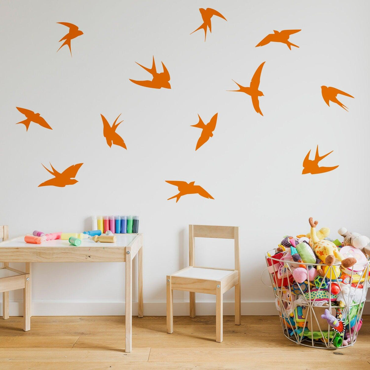 12 orange flock of birds wall stickers on a child’s room wall, adding playful decor to the space.