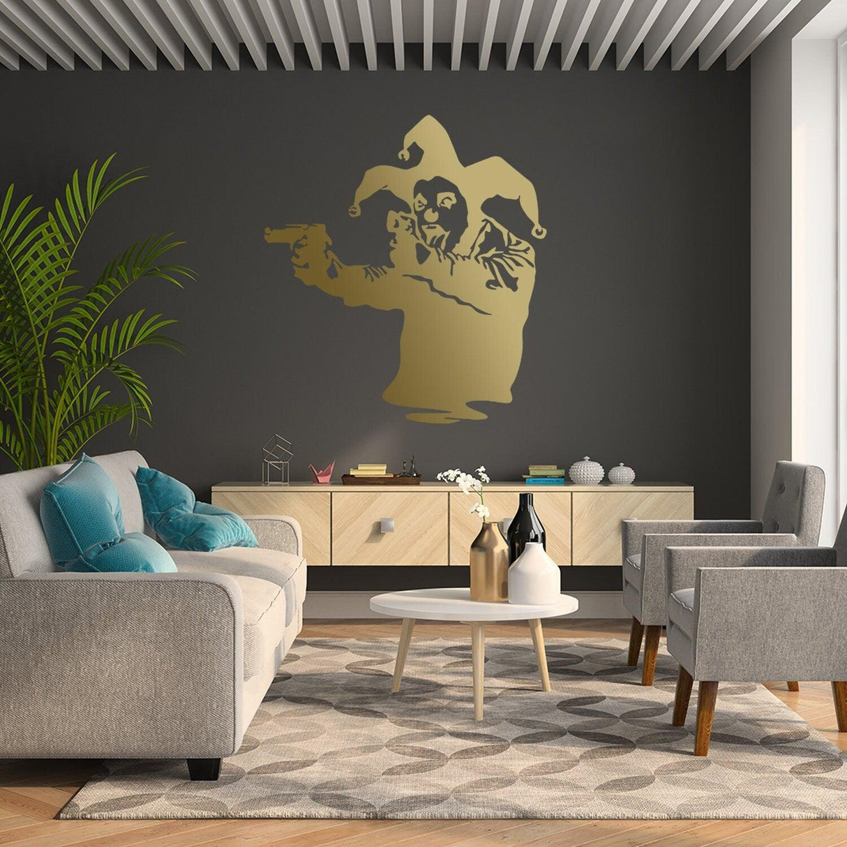 Banksy vinyl wall decal of a Joker clown holding a gun, stylishly displayed in a modern living room.