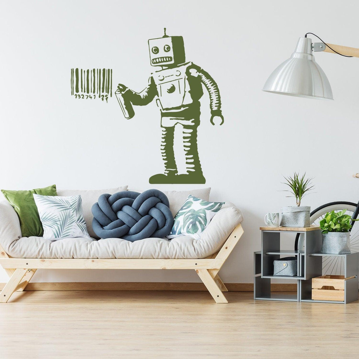 Banksy Barcode Robot Wall Vinyl Sticker on a modern living room wall above a stylish sofa with green decor.