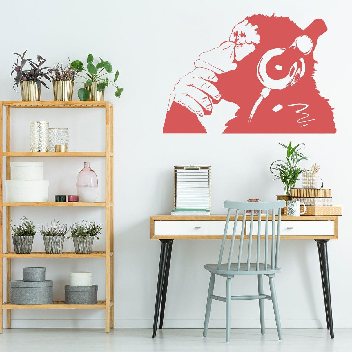 Banksy Thinking Monkey Wall Sticker in red, featuring a thoughtful monkey with headphones in a modern room setting.