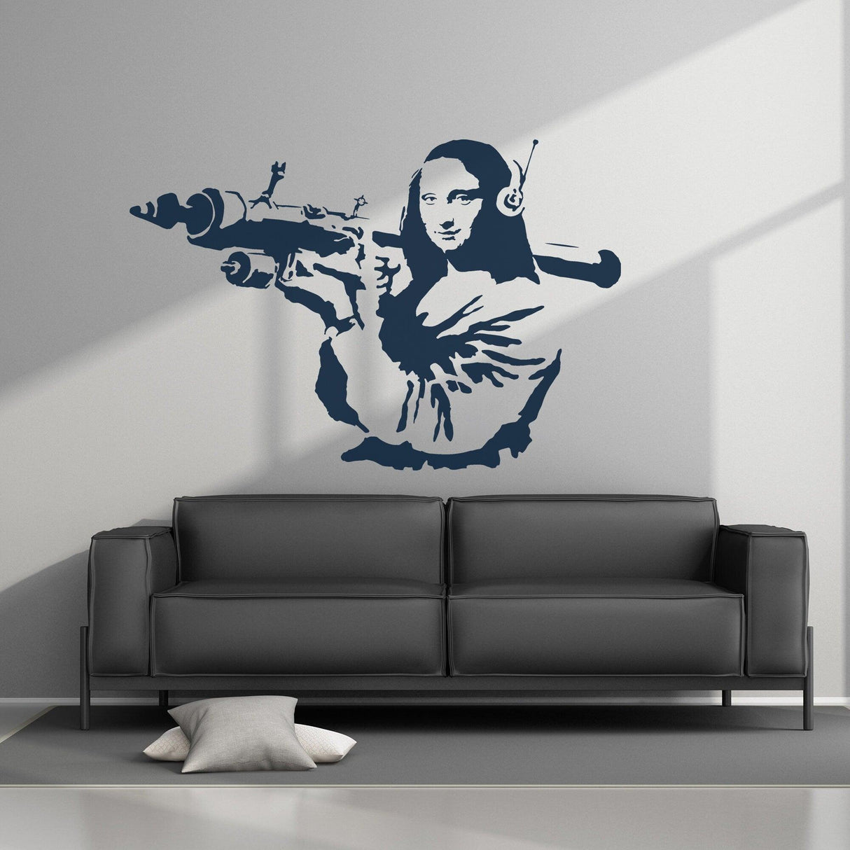 Banksy Mona Lisa wall sticker featuring a modern twist with headphones and a weapon on a smooth wall above a sofa.