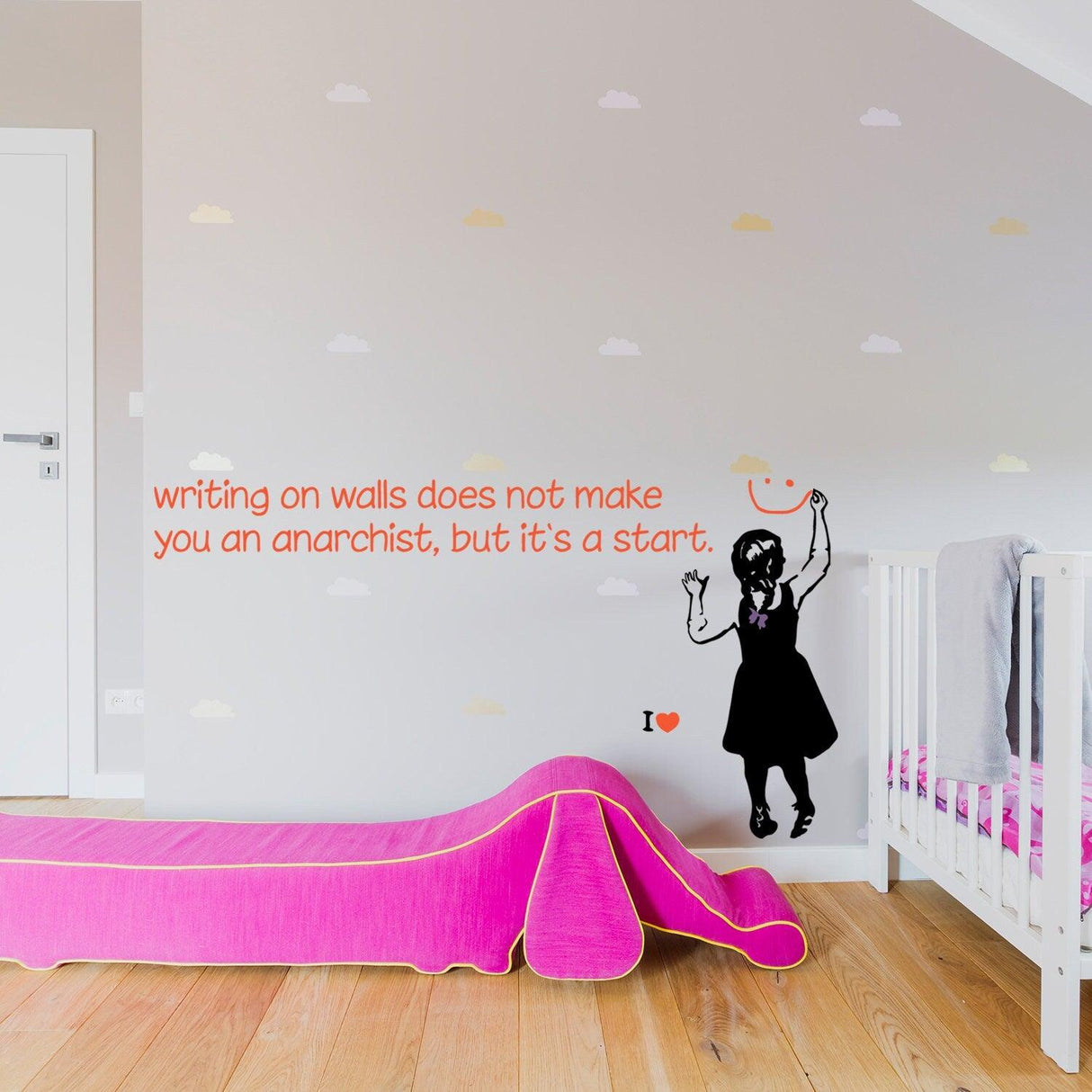 Banksy girl wall sticker with quote in colorful nursery, showcasing rebellion and creativity on a smooth surface.