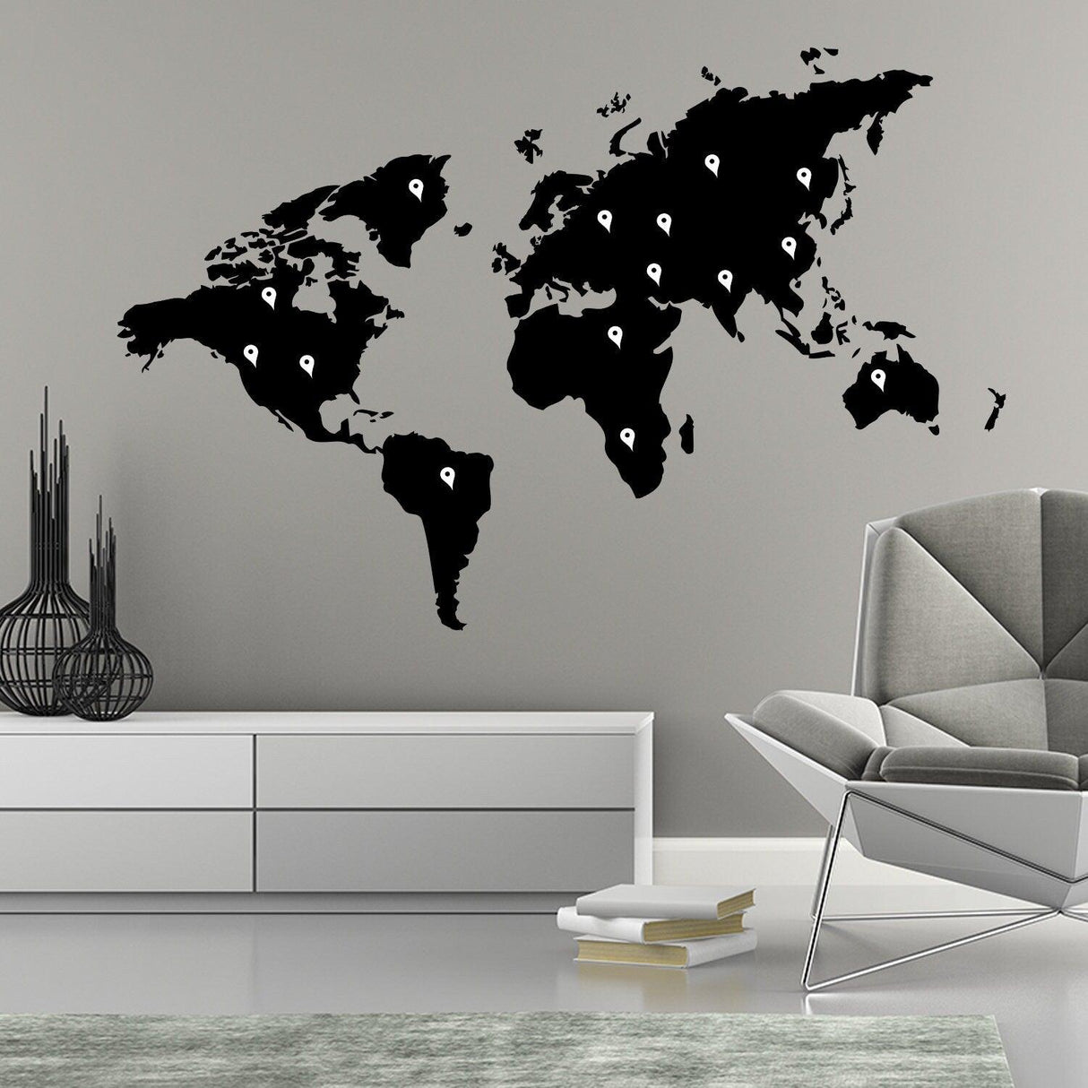World Map Vinyl Sticker wall art in black on a grey wall above modern furniture.